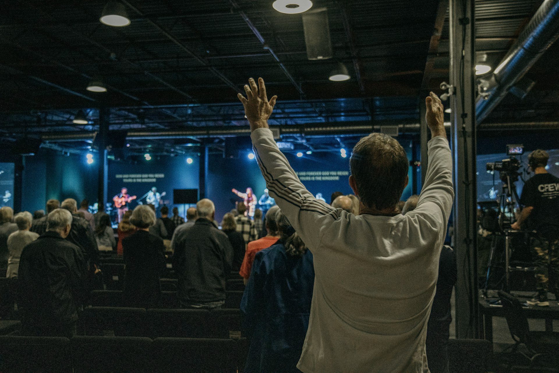Worship leader standing before congregation